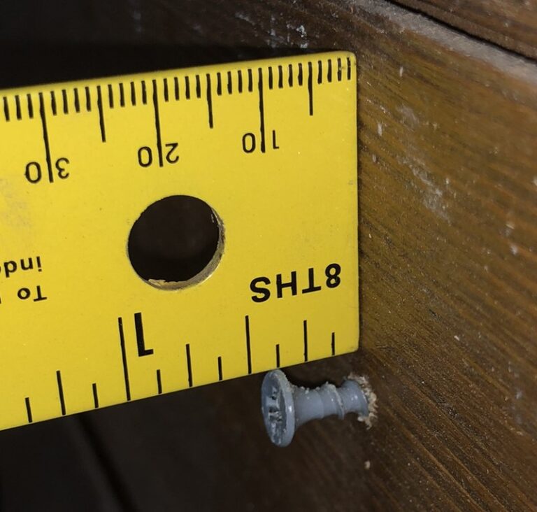 Drywall screw and ruler, showing screwhead sticking out 3/8 inch to hang stone