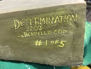 Engraving on side of base, showing "Determination 2003"